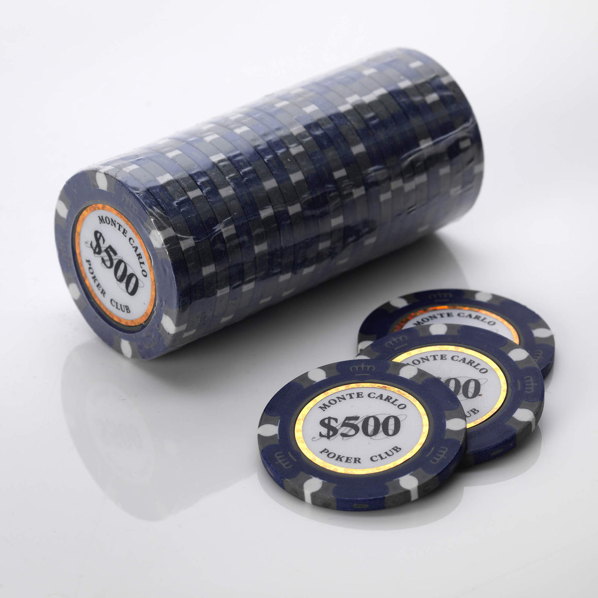Wrapped roll of dark blue Monte Carlo poker chips with three loose chips in front of it