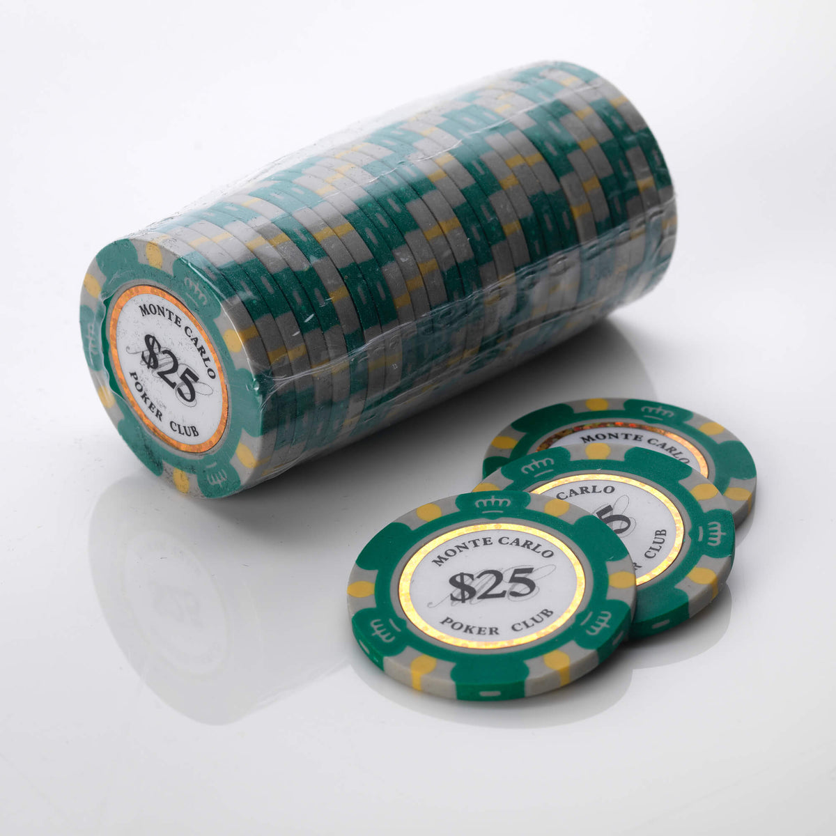 Wrapped roll of green and gold Monte Carlo poker chips with four loose chips in front of it