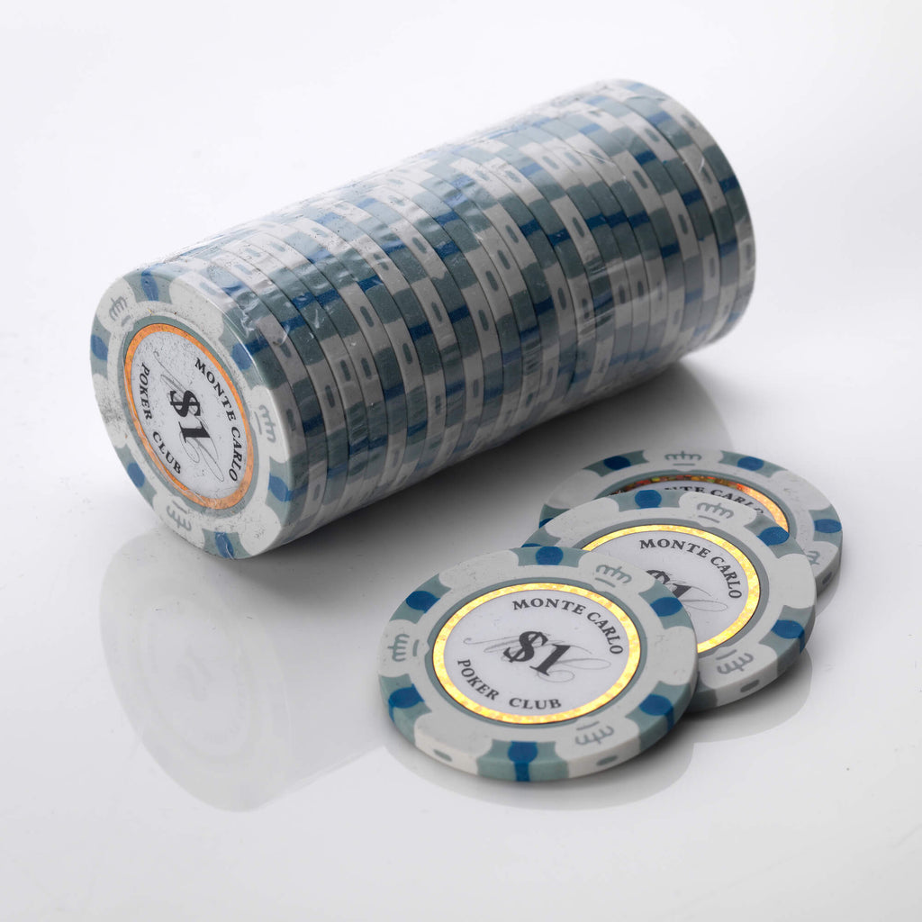 Wrapped roll of white and blue Monte Carlo poker chips with three loose chips in front of it