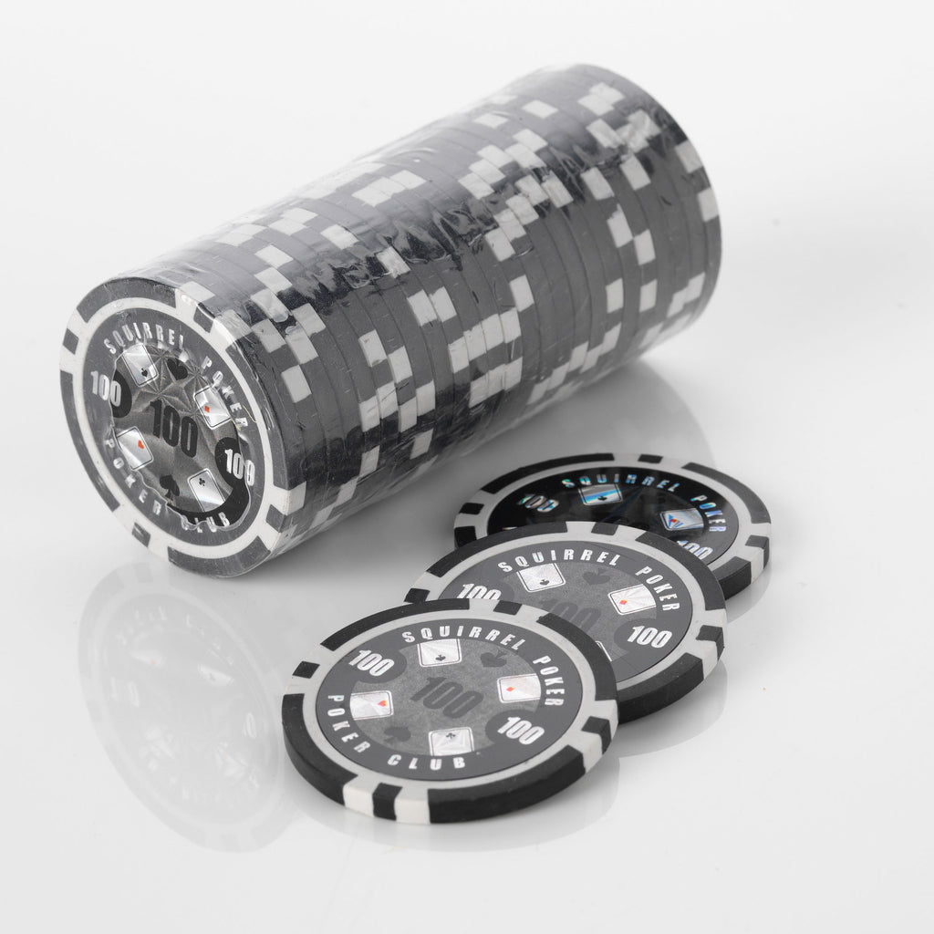 Stack of black and white Squirrel Poker Club poker chips with three loose chips in front of it