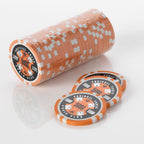 Stack of orange and white Squirrel Poker Club poker chips with three loose chips in front of it
