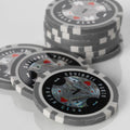 Close-up of a stack of black and grey Squirrel Poker Club poker chips with playing card suit designs