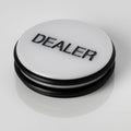 Large white 3 inch poker dealer button with DEALER printed in black lettering