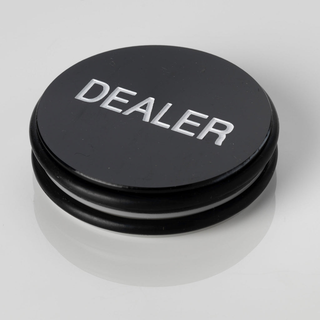 Large black 3 inch poker dealer button with DEALER embossed in white lettering