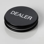Large black 3 inch poker dealer button with DEALER embossed in white lettering