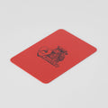Red plastic Modiano card cut for poker and blackjack dealing, with a printed black logo