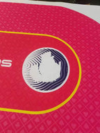 Close-up of the red poker table mat with yellow betting line and white logo