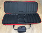 Open black EVA poker chip case with red trim, empty chip trays and a small carry pouch