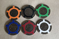 Six Tangiers Casino poker chips in orange, black, green, blue, red and white