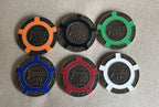 Six Tangiers Casino poker chips in orange, black, green, blue, red and white
