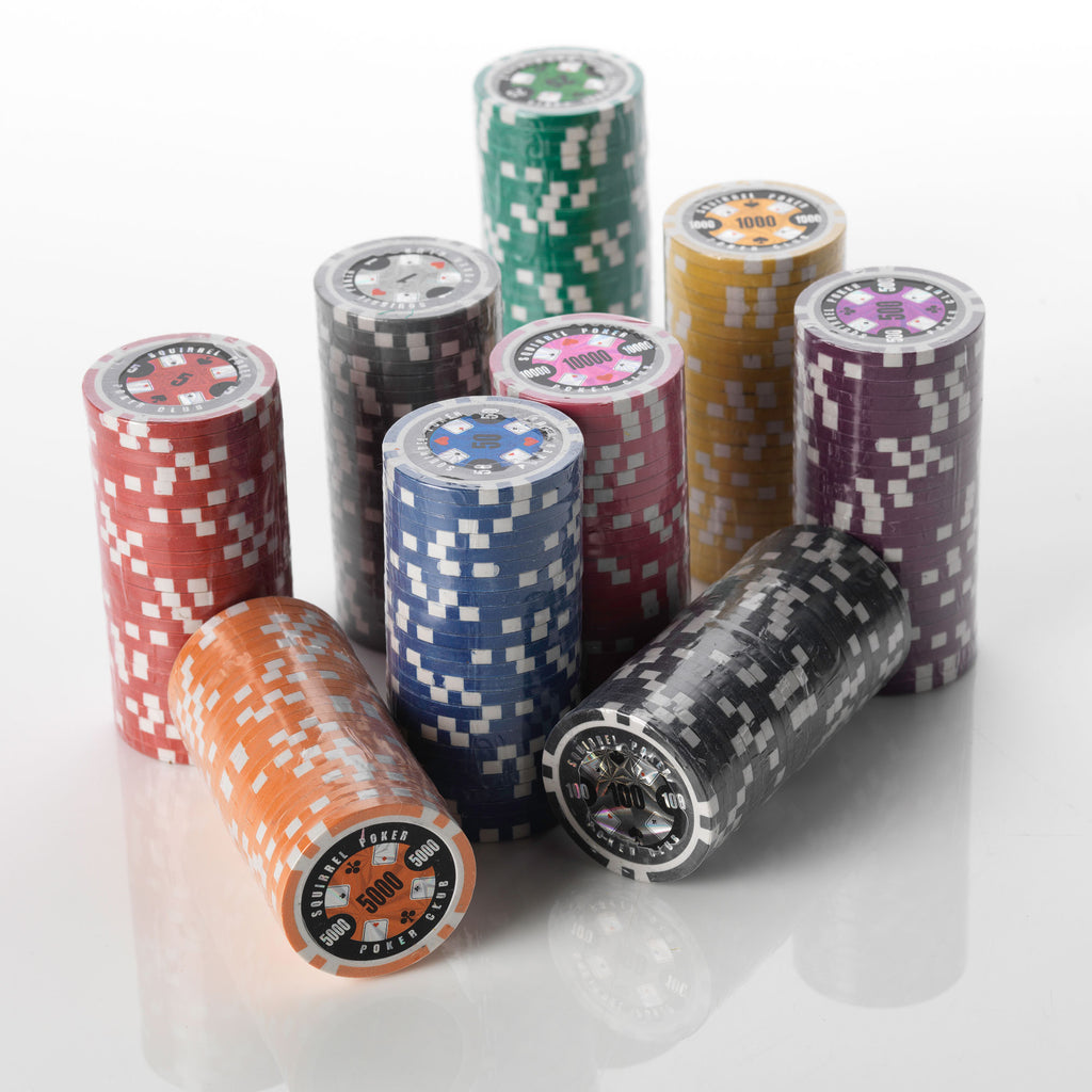 Stacks of Poker Club clay poker chips in multiple colours